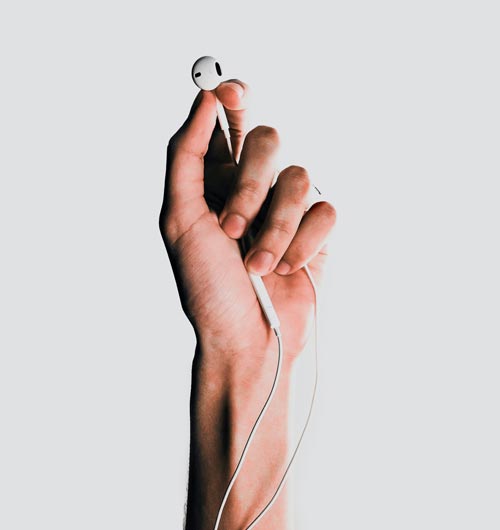 Image of person holding headphones