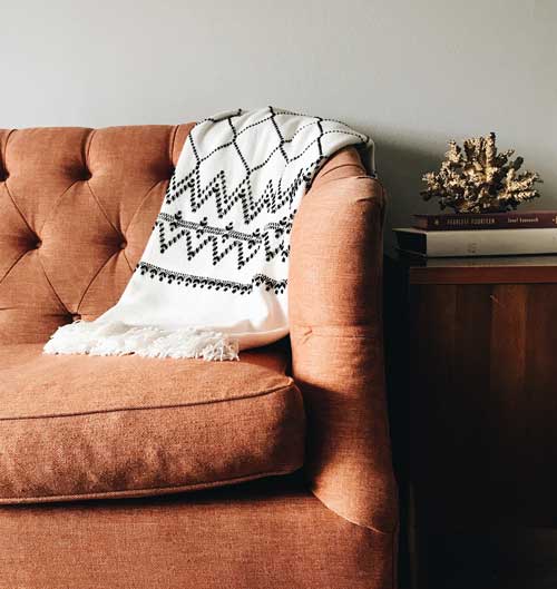 Couch with a blanket over it