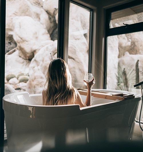 Woman in a bath overlooking nature