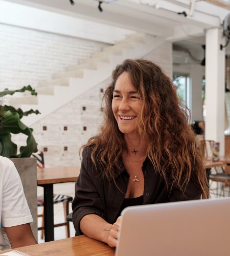 Image of woman smiling with her laptop